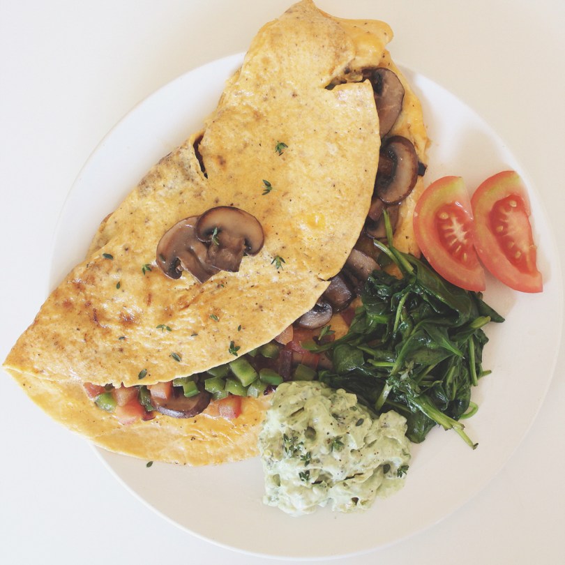 Cheesy Mushroom Omelette with Avocado Mint Greek Yoghurt & Wilted Spinach