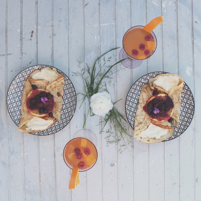 French Crêpes with a Honeyed Citrus Creamcheese Filling topped with a Mixed Berry Compte; Orange Sunrise Cocktail